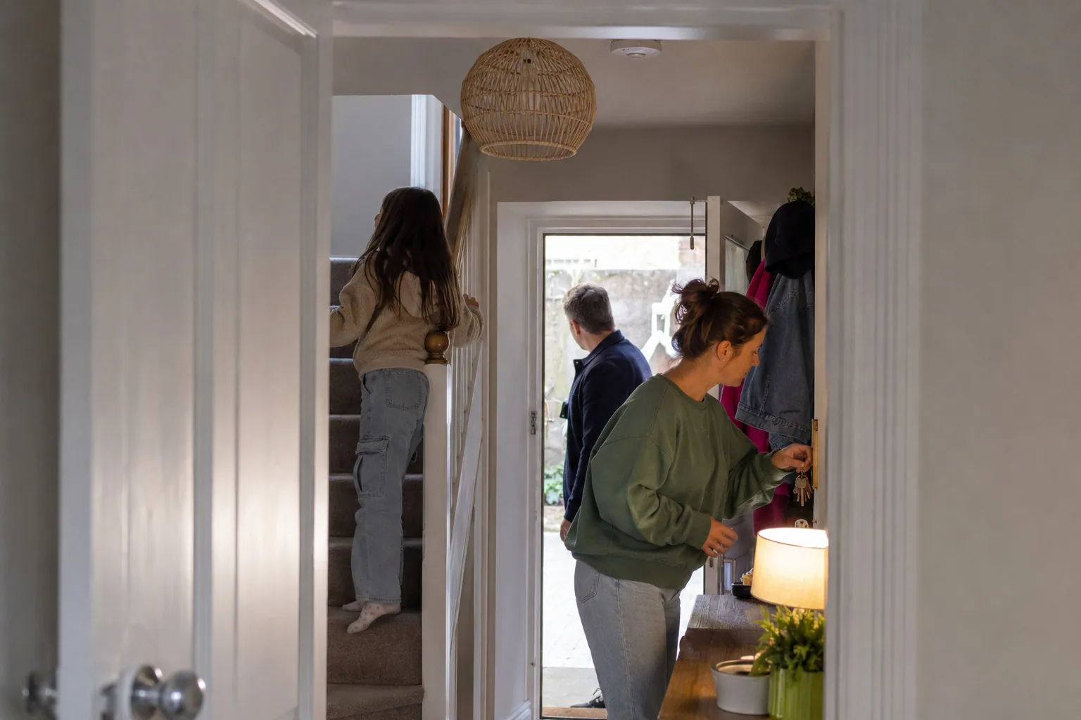 Family members going about their day in a shared hallway