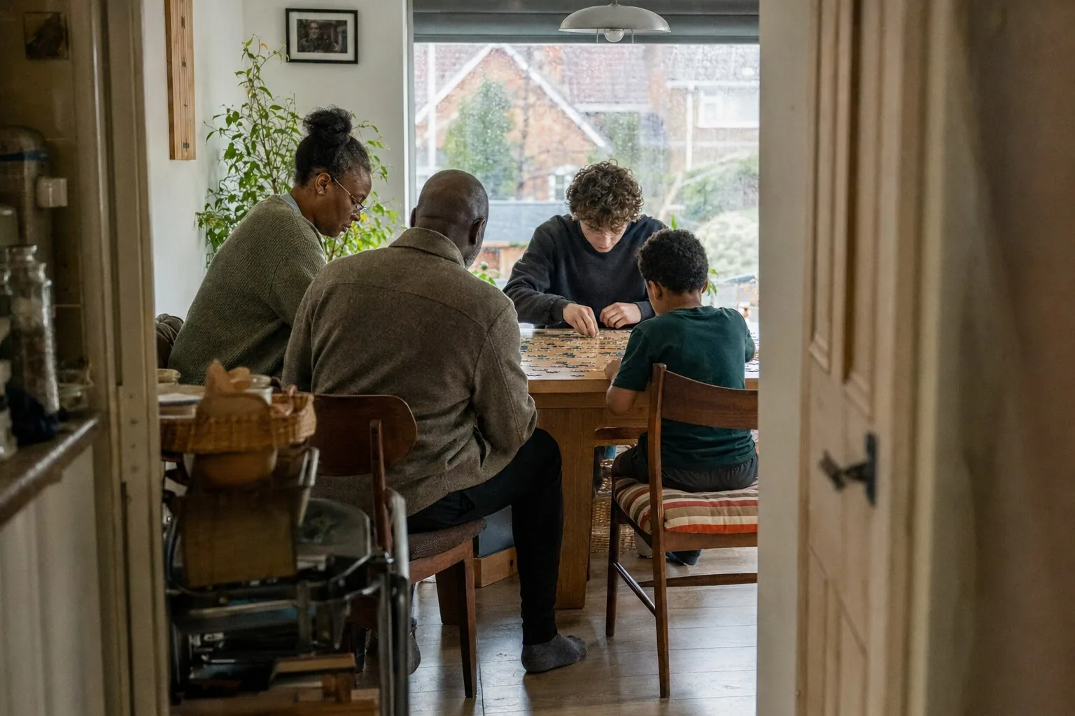 Adults and children sharing time around a kitchen table