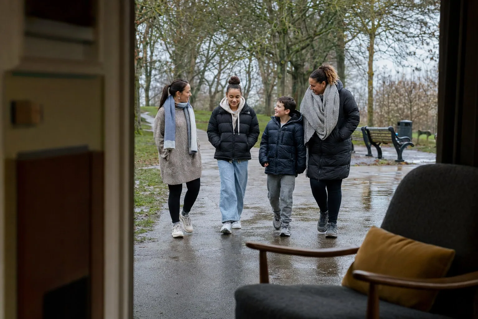 Adults and children walking together through a leafy park