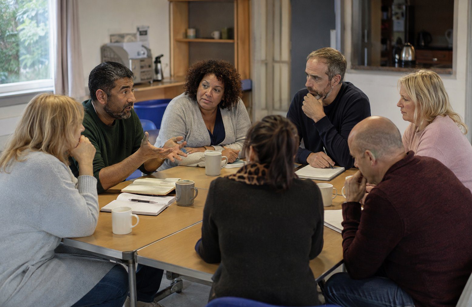 A small group of adults taking part in a relaxed training discussion